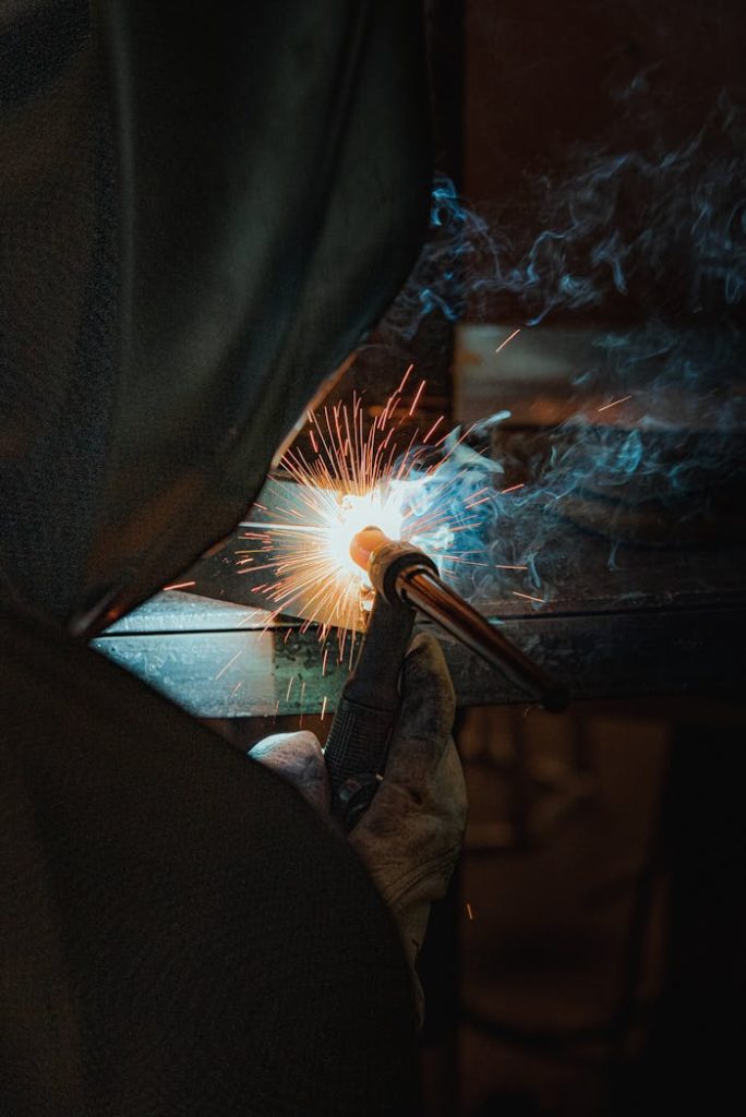 Professional Welding & Metalwork Recruitment | Elmiron Welder working with sparks during metal fabrication — industrial recruitment illustration