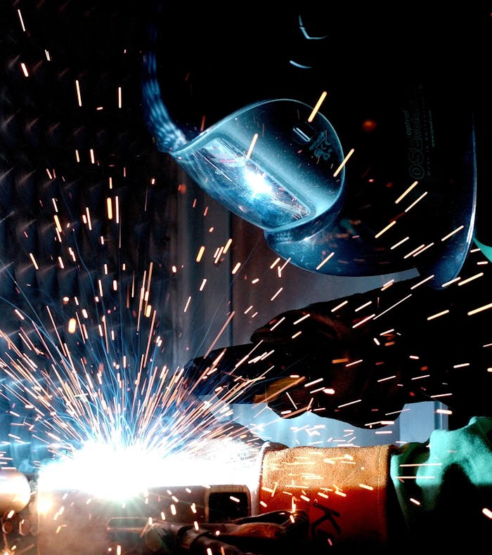 Skilled welder working with precision and sparks in a modern industrial workshop — representing Europe’s growing demand for professional welders.