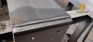 Industrial steel fabrication detail showing welded metal surface – Elmiron